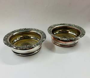 Alcohol And Tobacco: Pair of antique ornate silver plated over copper wine bottle coasters