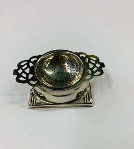 Silver plated tea strainer in stand
