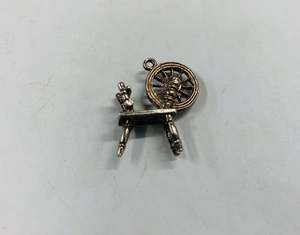 Silver spinning wheel charm