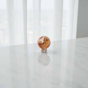 Carnelian polished crystal sphere on stand
