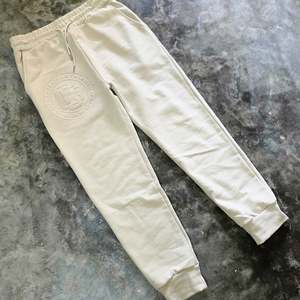 Monogram Embossed Trackpants - Stone
