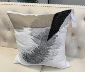 Grey,white,lack, and cream cushion