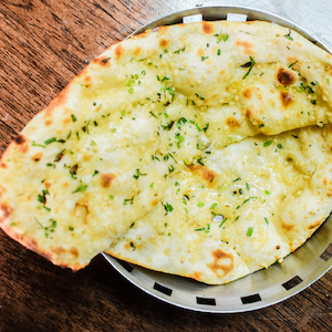 Cheese Garlic Naan - Curry Guru Tweed Street