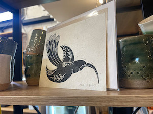 Huia hand carved and stamped on harekeke paper A5 Epic Aotearoa