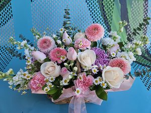 Products: EA0526 pastel flowers in basket - Flavells Floral Boutique