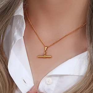 Jewellery: Flying Saucers gold bar pendant