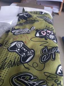 Activewear: Video games on Olive - Cotton Spandex - 1 metre remnant - print mark on fabric