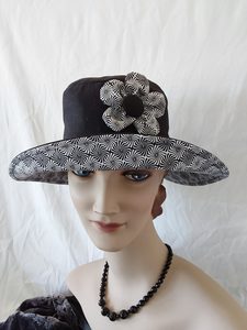Products: R250: Black linen/cotton hat with geometric design trim and 5 petal flower feature. Hokianga Hats