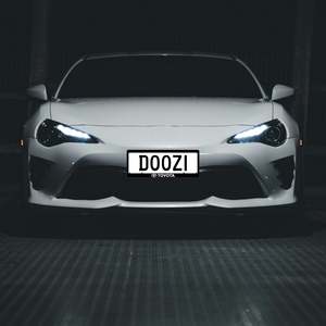 Automotive branded number plate surrounds
