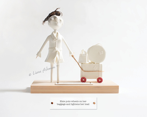 Print: Elsie puts wheels on her baggage and lightens her load