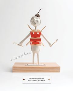 Products: Print: Delwyn adjusts her armour and battles on