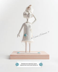 Print: Patched and repaired, Annie adjusts her crown and battles on