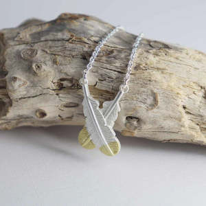 Necklaces: Little Taonga | Crossed Huia Feather