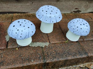 Garden Decor Pick Up Only: Set of 3 light purple concrete mushrooms.