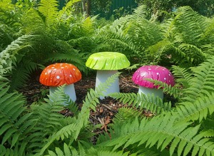 Set of 3 multi coloured concrete mushrooms.