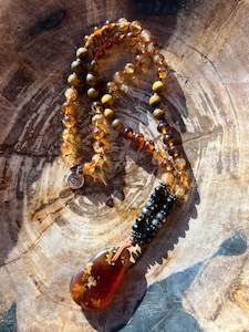 Malas: Mālā with Rare Blue Amber, Citrine, Tigerseye and Onyx Beads with a Blue Amber Pendant