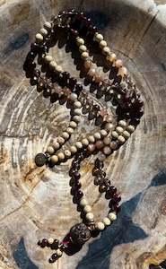 Malas: Mālā with Garnet, Smoky Quartz, Sunstone and Lotus Seed Beads with a Carved Lotus Guru Bead/ Pendant