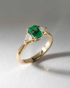 Bespoke Rings: Octagonal Emerald Flanked by Diamond Trillions
