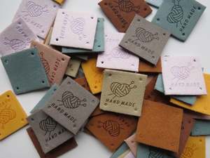 Labels: 12 Mixed Colour Heart with wool wrapped around  it with knitting needles Hand made PU leather labels. 25 x 25mm