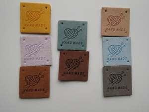 Labels: 25 Mixed Colour Heart with wool wrapped around  it with knitting needles Hand made PU leather labels. 25 x 25mm
