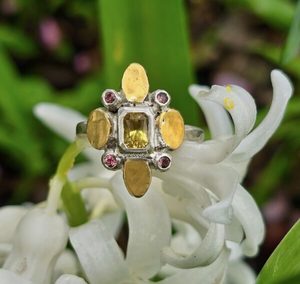 Products: Fleurette ring. radiant cut Sri Lankan 6x4mm yellow sapphire, peach sapphires, silver, and 24ct gold. Size O 1/2 - Penelope Barnhill Jewellery