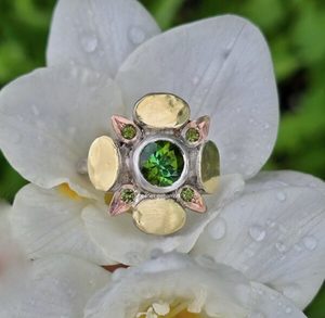 Products: Florette ring. 7mm green tourmaline, tourmaline, silver, 18ct green and red gold. Size O - Penelope Barnhill Jewellery