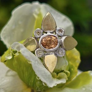 Products: Florette ring. 7x6mm oval imperial topaz from Ouro Preto, four natural gold diamonds, silver, and 18ct green gold. Fingers 50th Anniversary show. - Penelope Barnhill Jewellery