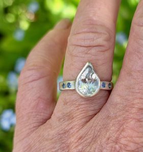 Products: Brazilian white topaz pear ring with blue sapphires in sterling silver. Size N - Penelope Barnhill Jewellery