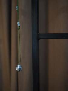Accessories: Silver Moon Shell on Green Silk Necklace