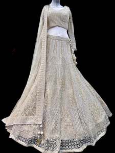 Womens: (Video clip attach)size 40(upto 44)fully stitched Lite Gold beige color engagement /semi bridal lehnga with full of stones & embroidery work heavy multi flared and with very heavy embroidery work netting dupatta and blouse piece