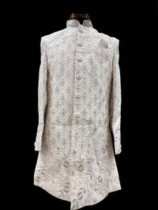 Indo Western: (Video clip attached )Cream Gold Beige color pink color heavy embroidery work all over with hand work pearl beaded neck, buttons and sleeves design Sherwani and Pants