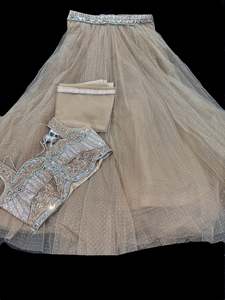 Crop Top: Netting based stones with mirror work designer blouse with shimmery netting heavy flared lehnga and netting based sequined work dupatta