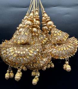 Beautiful golden design medium size lehnga latkans tessels (pair)