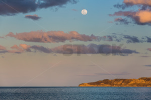 Products: The Moon rising over Cape Kidnappers, Te Awanga, Hawke's Bay, New Zealand - SCP Stock