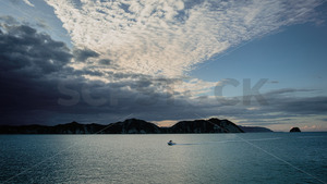 Products: A fishing boat returing to the bech in Tolaga Bay, East Coast New Zealand - SCP Stock
