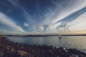 Products: A small sailing yacht departs Ahuriri Harbour, Napier, New Zealand - SCP Stock