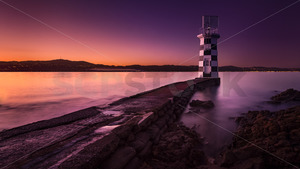 Products: Point Halswell Lighthouse with the Interislander Ferry Passing by (long exposure), Wellington, New Zealand - SCP Stock
