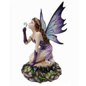 Fairy on stump blowing bubbles