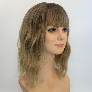 Light brown to caramel blond ends. Sole Wig Works