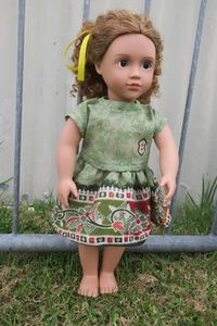 Products: Doll skirt and top, green with patterned border, fits 46cm dolll