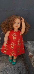 Products: Red pinafore dress, reindeer print, fits 46cm doll