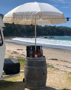 Furniture: Wine Barrels - Grey with Fringe Umbrellas (Hire Price & Pickup Only)