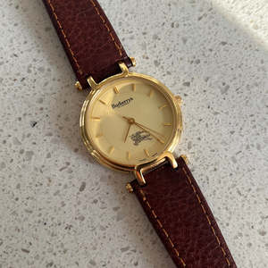 Tiny But Mighty: Burberrys Gold Lady Watch with Sculpted Loop Lugs and Champagne Dial 32mm Diameter