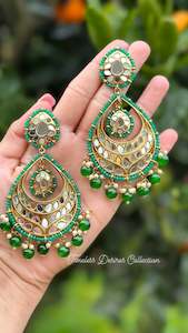 Green earrings in mirror