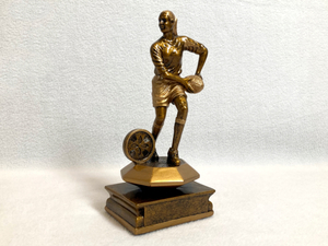 Female Rugby Player with Ball Trophy