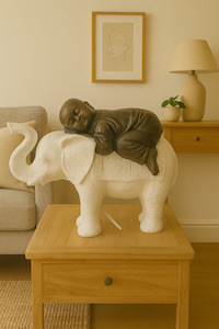 Baby Monk Sleeping on an Elephant statue