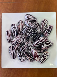 Products: Plastic Zebra Strip Oval Twist - Village Beads